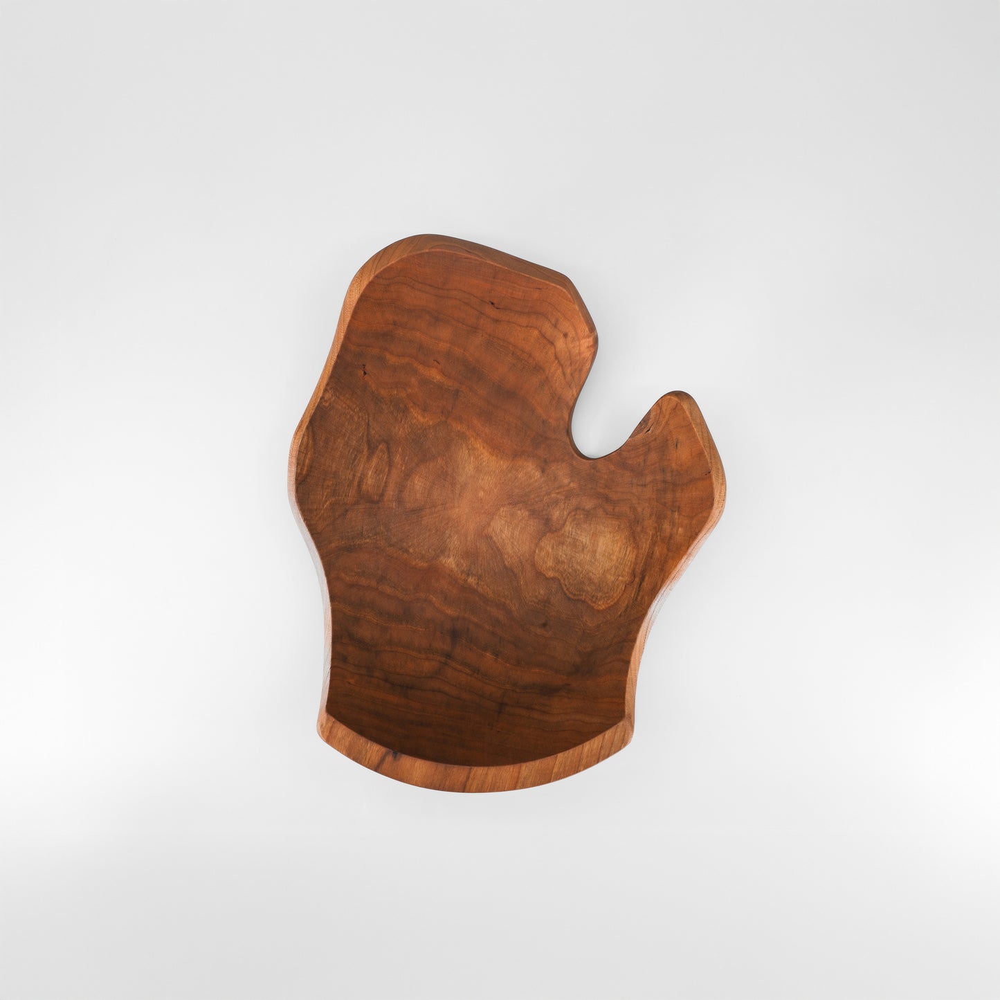 Wooden cutting board with a unique shape on a white background