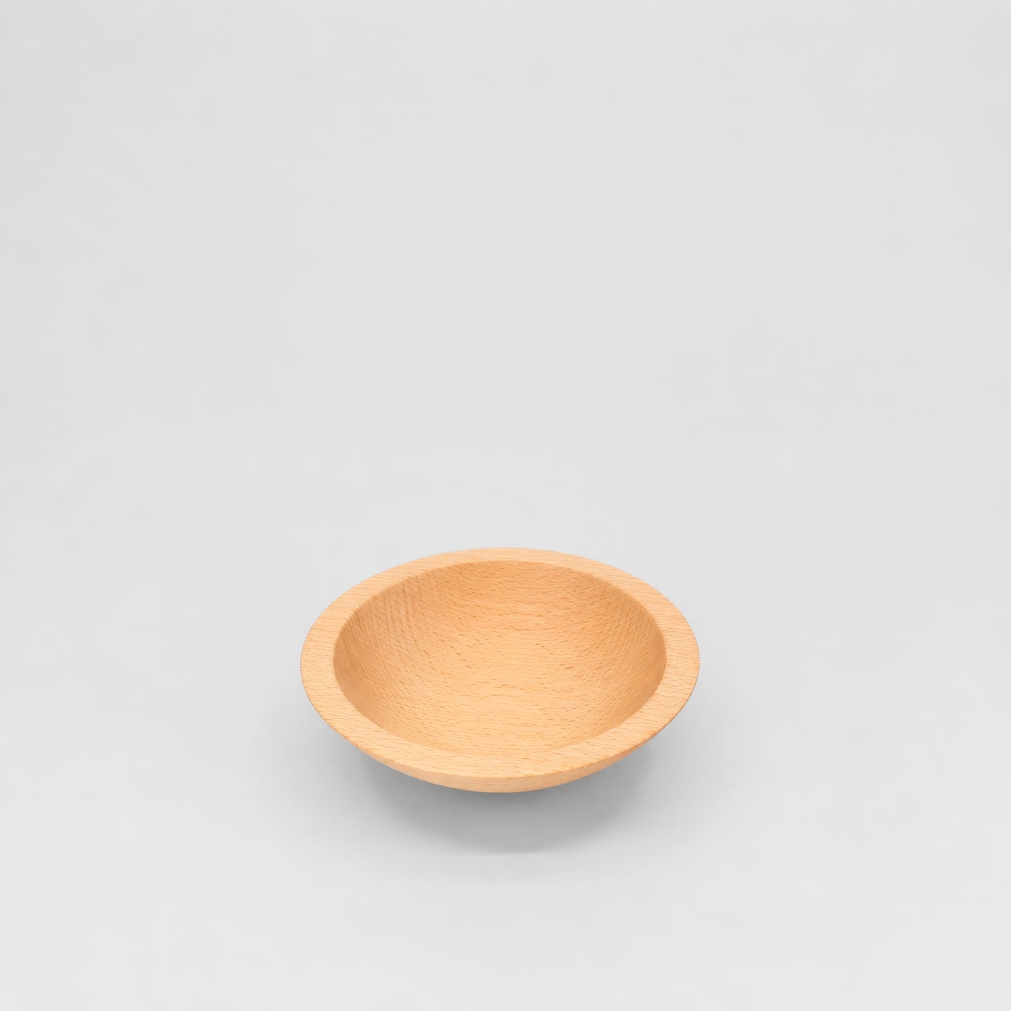 Wooden bowl on a light gray background