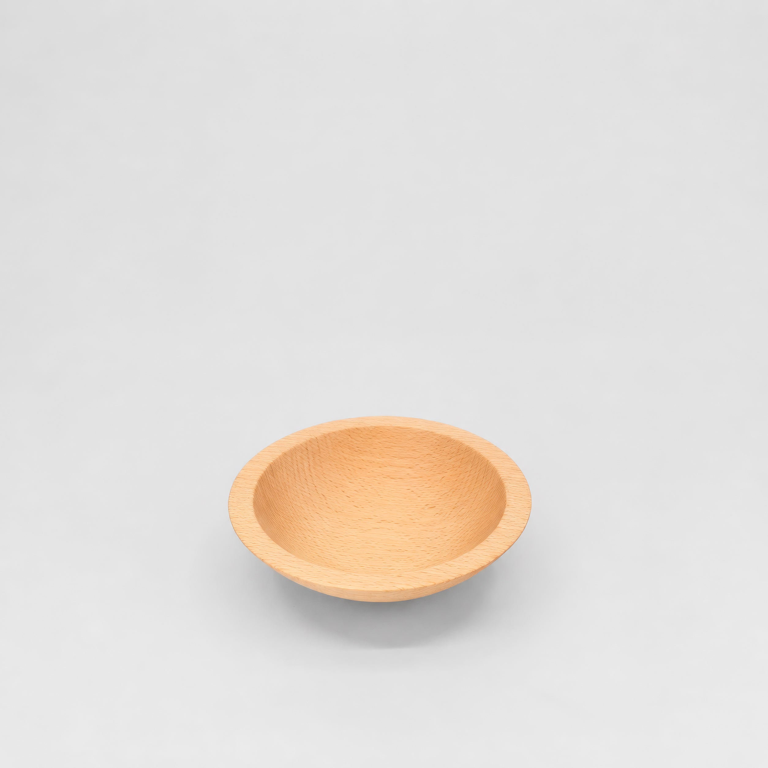 Wooden bowl on a light gray background