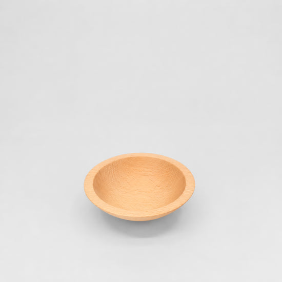 Wooden bowl on a light gray background