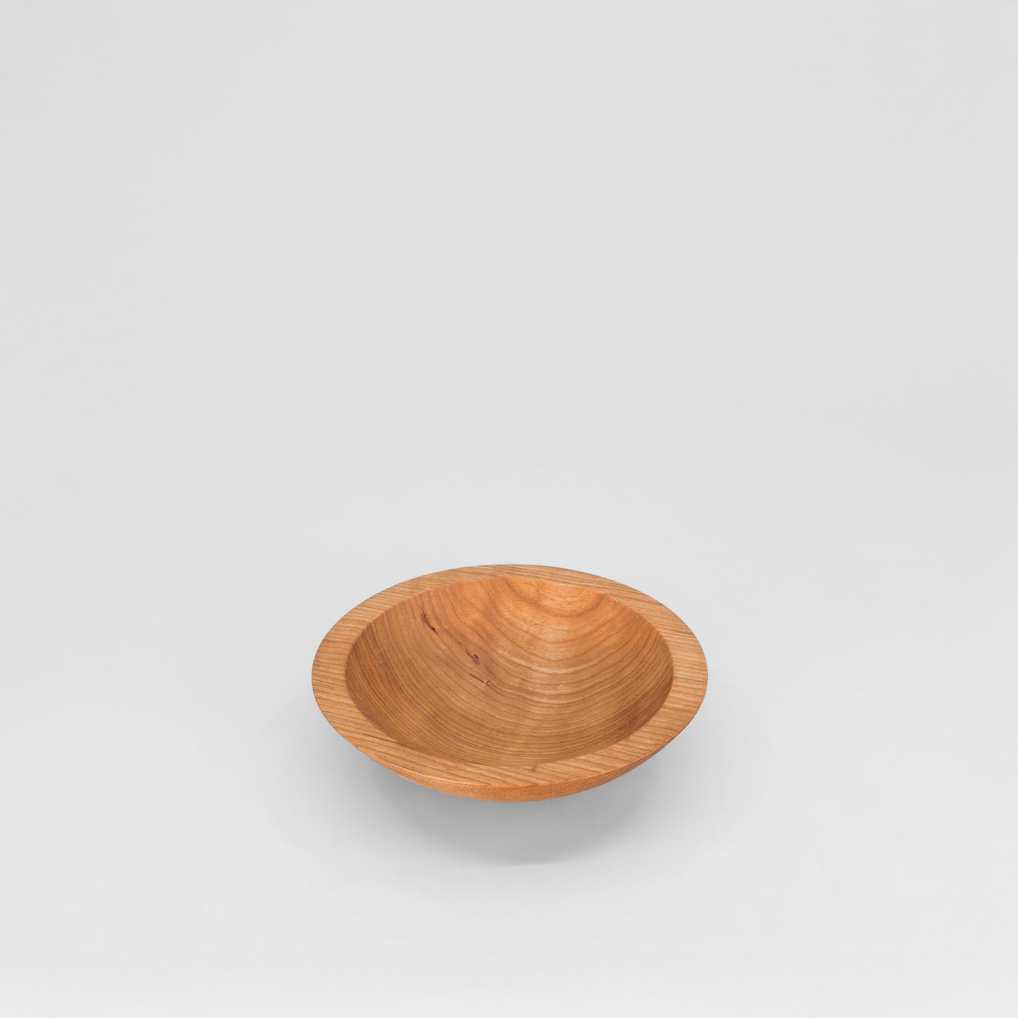Wooden bowl on a light gray background