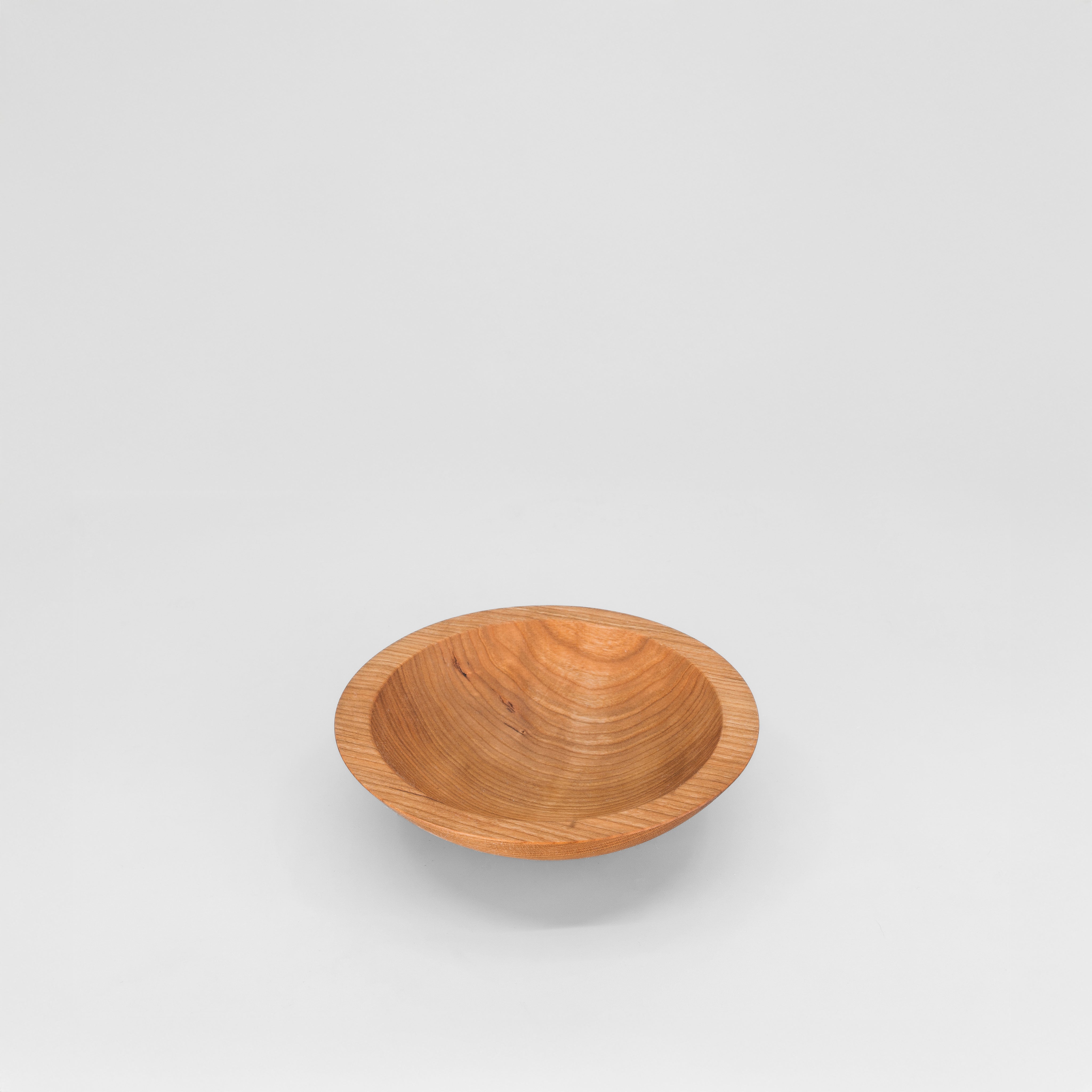 Wooden bowl on a light gray background