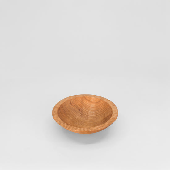 Wooden bowl on a light gray background