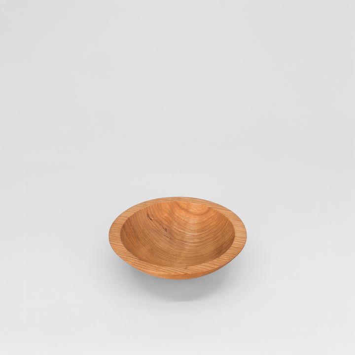 Wooden bowl on a light gray background