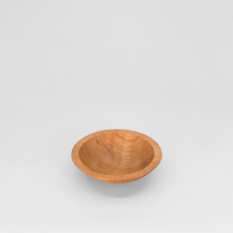 Wooden bowl on a light gray background