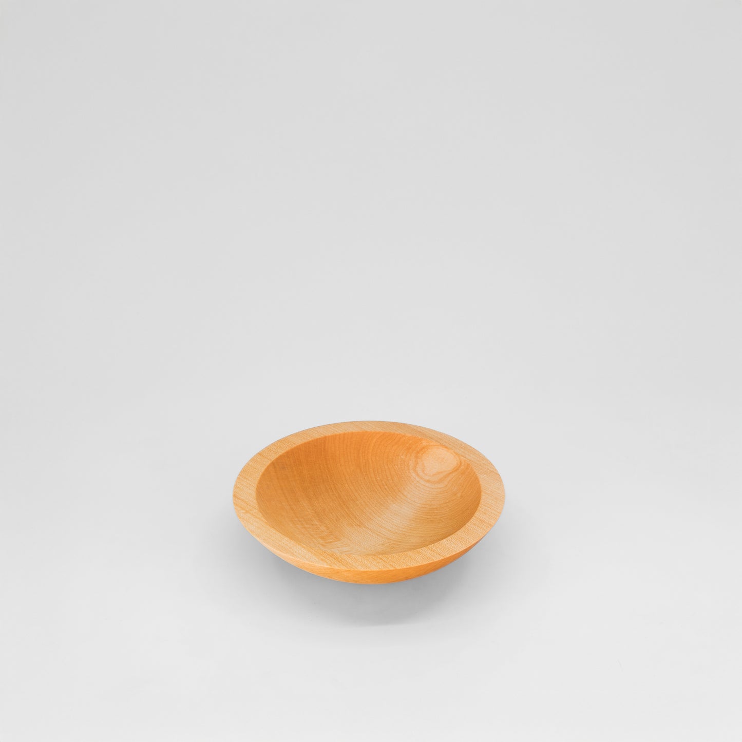 Wooden bowl on a light gray background