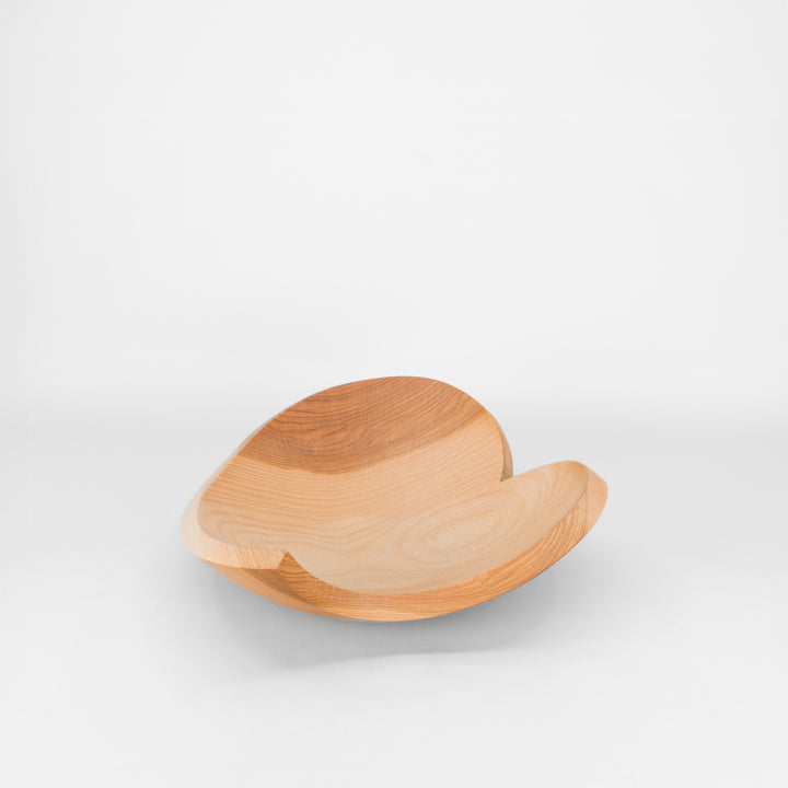 Wooden bowl with a unique design on a white background
