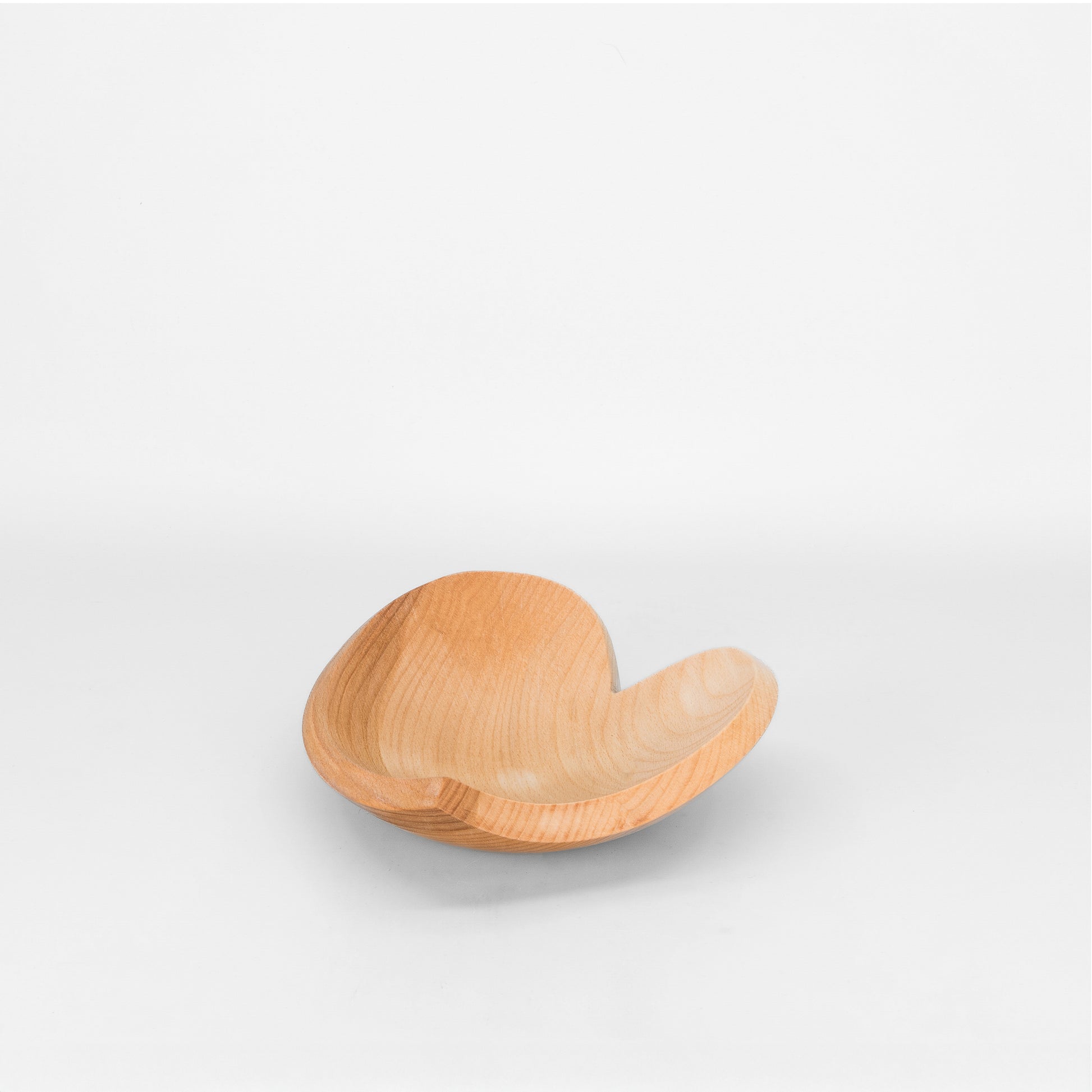 Heart shaped wooden bowl on light grey background