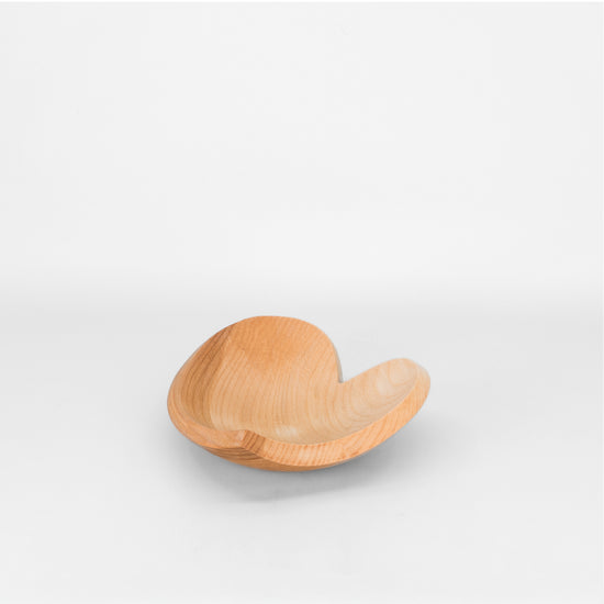 Heart shaped wooden bowl on light grey background