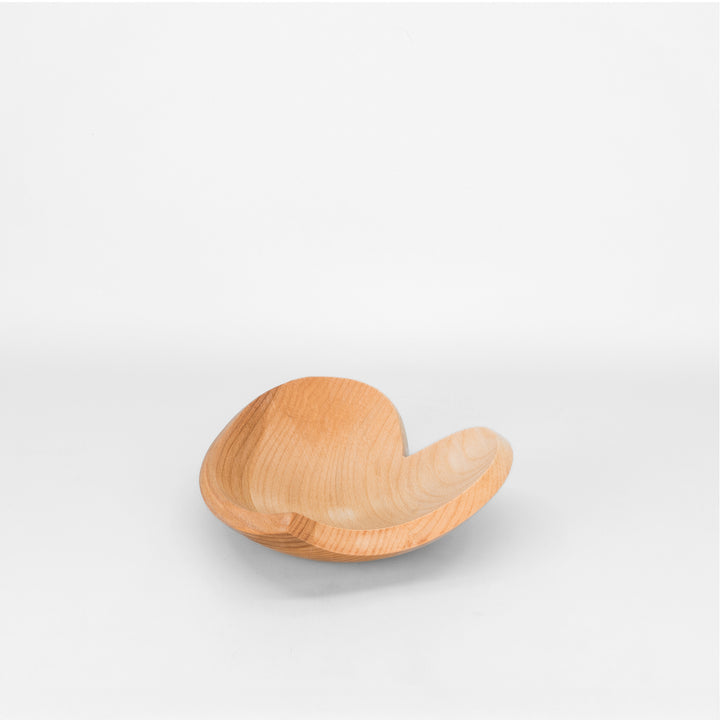 Heart shaped wooden bowl on light grey background