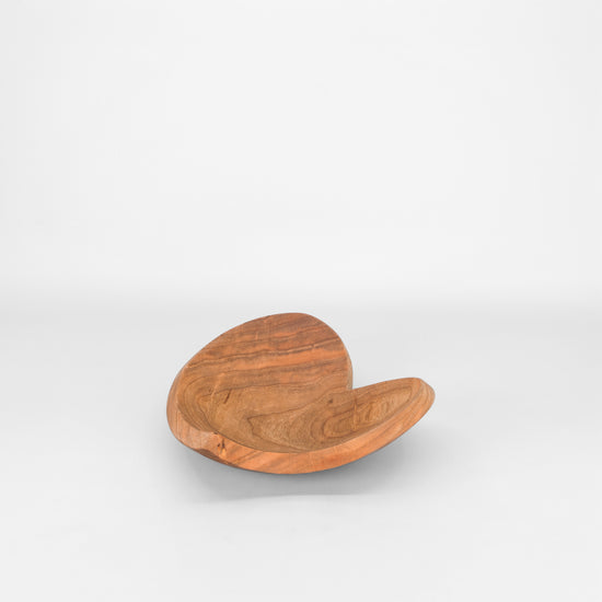 Heart shaped wooden bowl on light grey background
