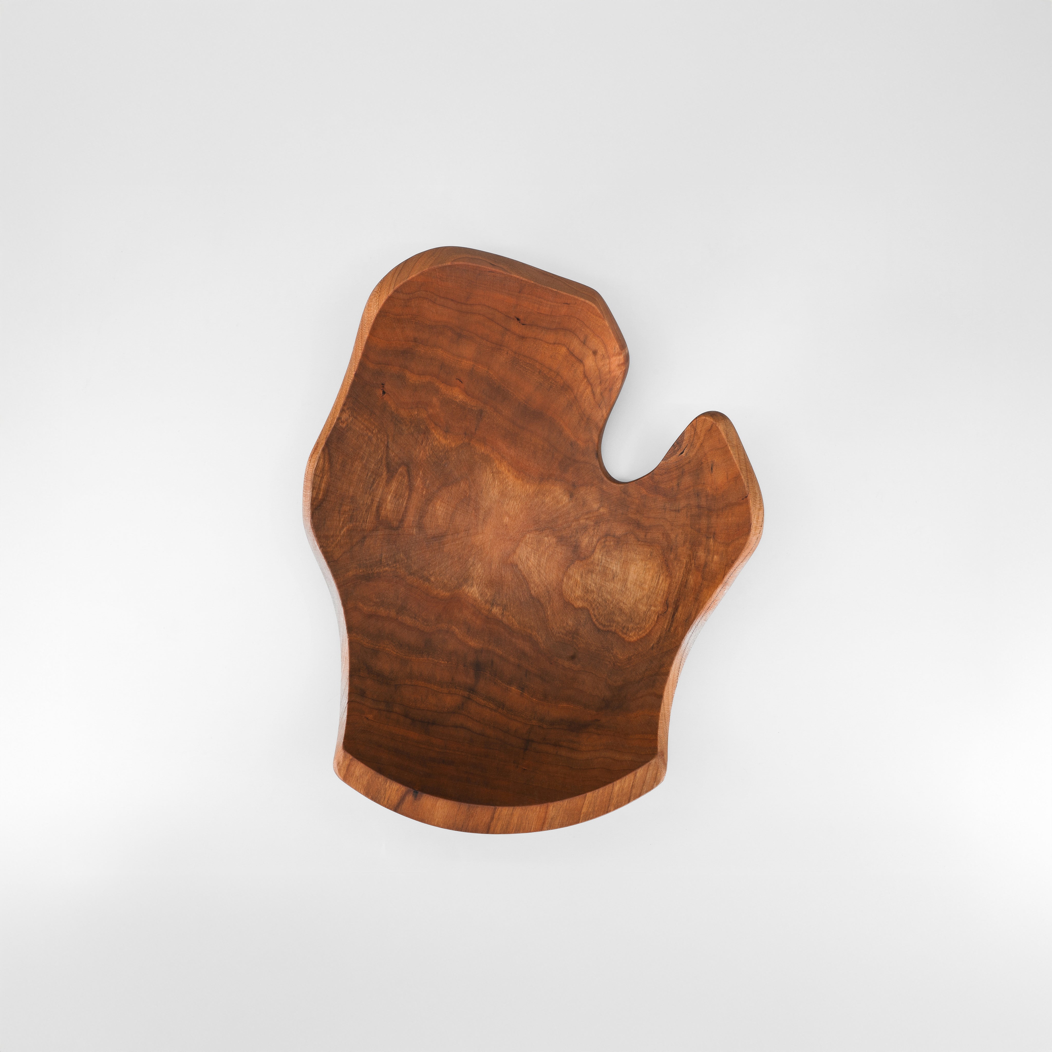 Wooden cutting board with a unique shape on a white background