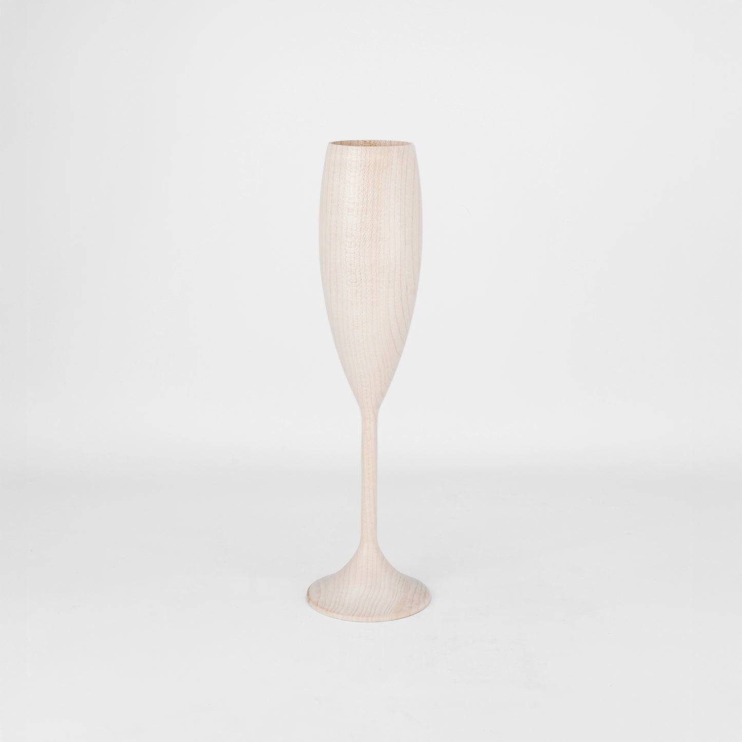 Light wood wine flute on a light gray background