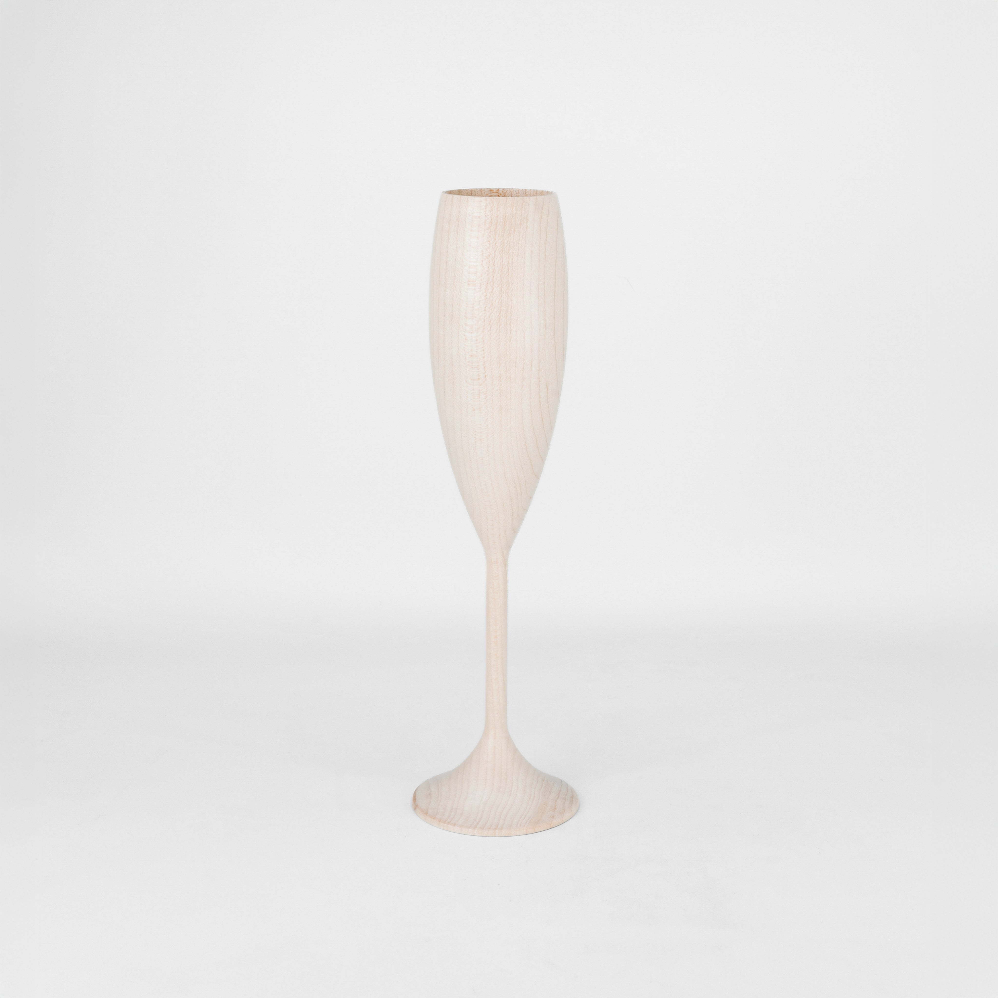 Light wood wine flute on a light gray background