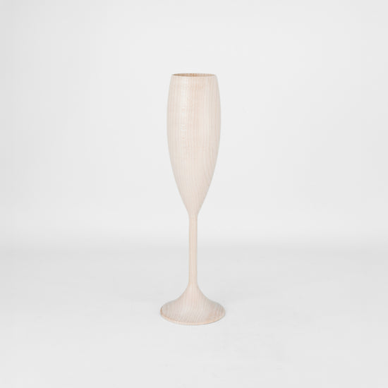Light wood wine flute on a light gray background