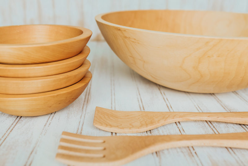 A Maple wood salad bowl set featuring four 7-inch bowls, one 17-inch bowl, and 14-inch utensils