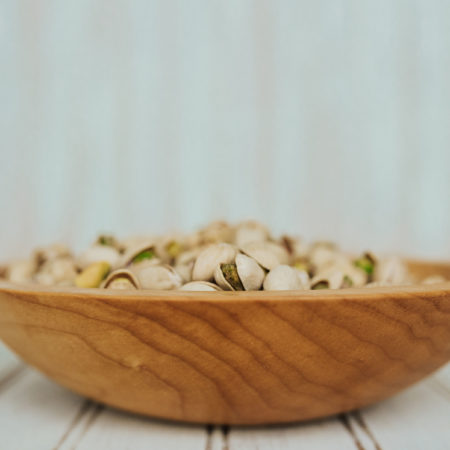 9-inch Maple bowl serves as a great large wooden snack bowl, like this one holding pistachios