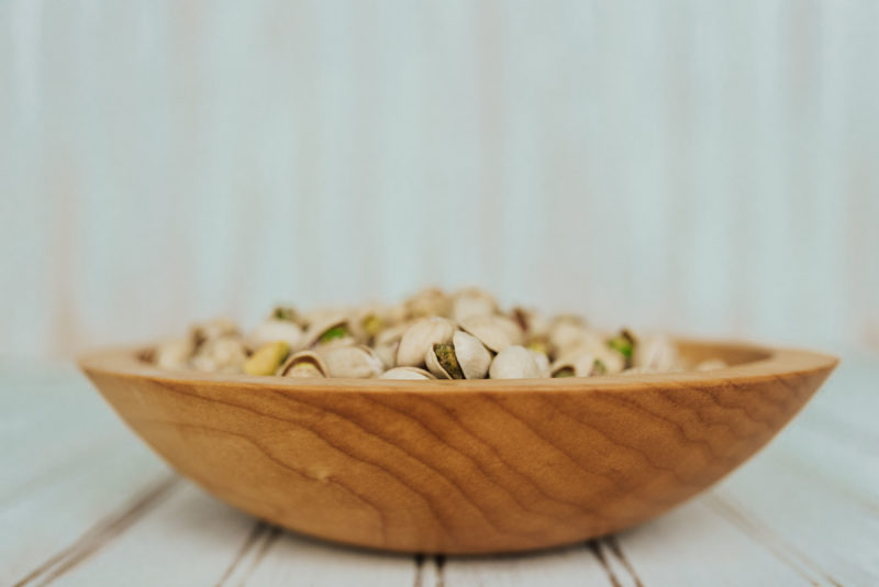 9-inch Maple bowl serves as a great large wooden snack bowl, like this one holding pistachios