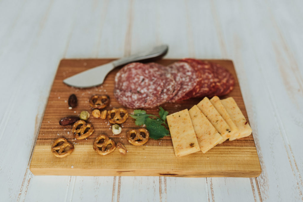 A charcuterie display on a Holland Bowl Mill cutting board. Part of a line of great corporate gift ideas.