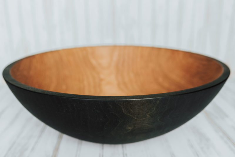 A 20-inch ebonized wooden bowl from the Holland Bowl Mill