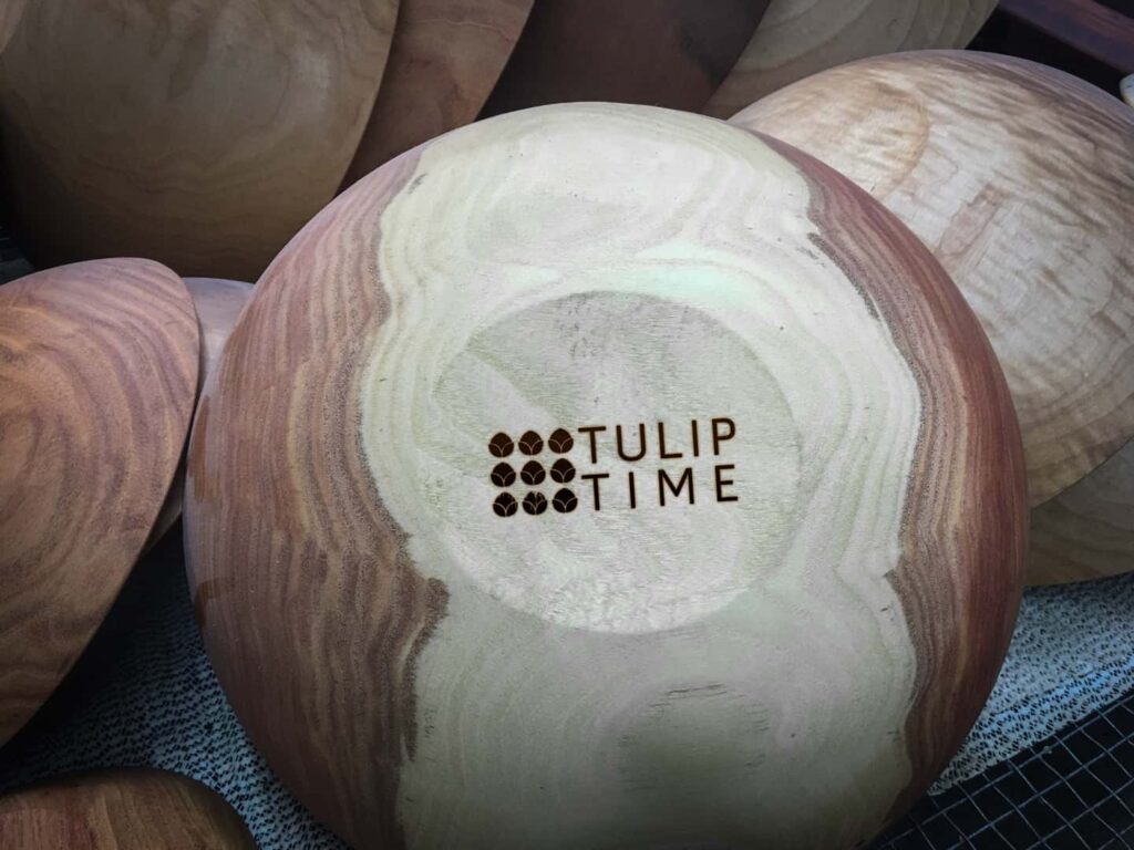 An example of corporate gift ideas by the Holland Bowl Mill. A 6-inch wooden bowl with Tulip Time's logo engraved on the bottom.