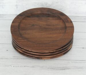 A large walnut wood plate stack of four