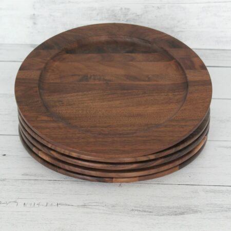 A large walnut wood plate stack of four