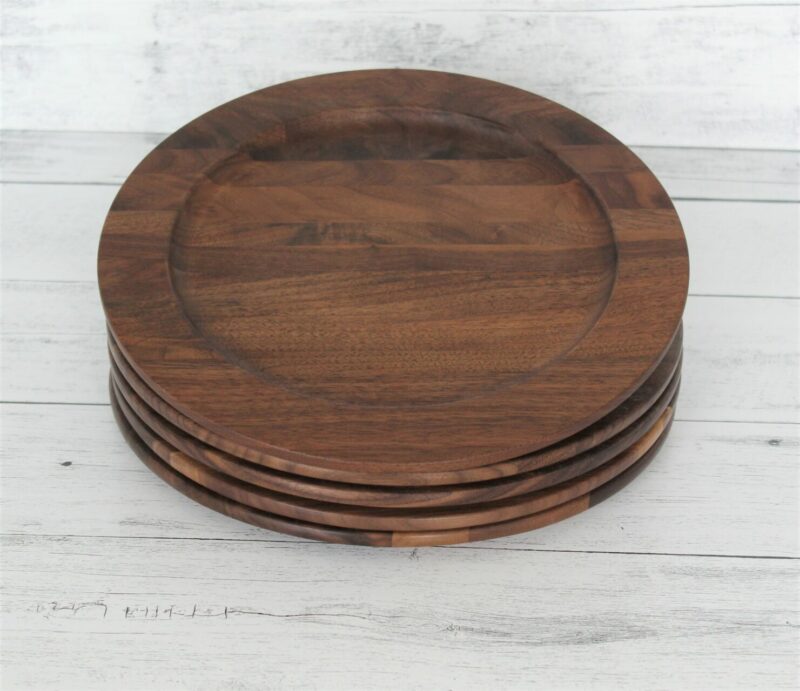 A large walnut wood plate stack of four
