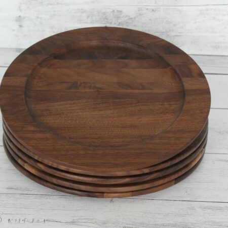 Four Walnut wood plates in a stack of four.