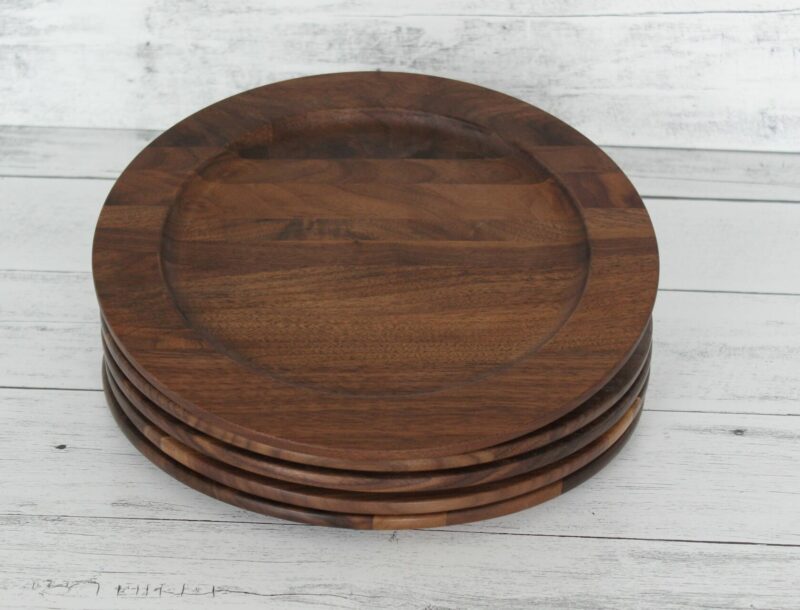 Four Walnut wood plates in a stack of four.