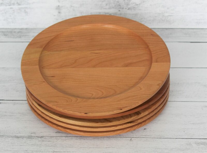 A large cherry wood plate stack of four