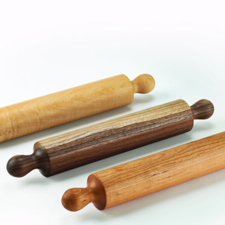Three wooden rolling pins based on the Shaker design (built-in handles) in Walnut, Cherry, and Maple wood sources.