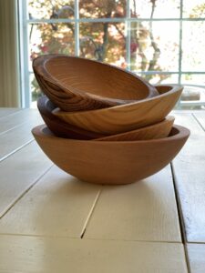 A stack of wooden bowls cradled into each other.