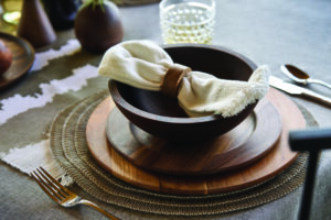 A place setting of wooden plates and bowl, from Holland Bowl Mill.